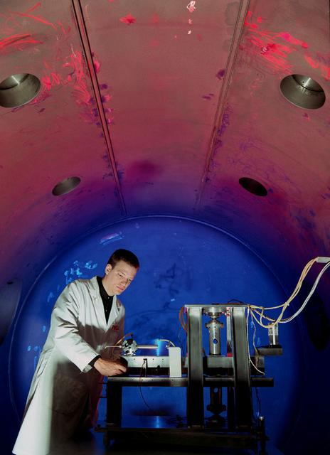 Engineers at one of MSFC's vacuum chambers begin testing a microthruster model. The purpose of these tests are to collect sufficient data that will enabe NASA to develop microthrusters that will move the Space Shuttle, a future space station, or any other space related vehicle with the least amount of expended energy. When something is sent into outer space, the forces that try to pull it back to Earth (gravity) are very small so that it only requires a very small force to move very large objects. In space, a force equal to a paperclip can move an object as large as a car. Microthrusters are used to produce these small forces.
