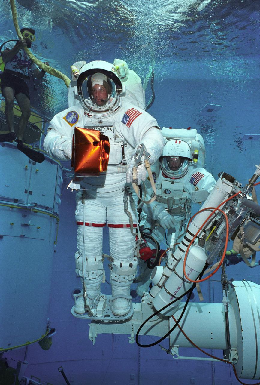 Astronauts Greg Harbaugh and Joe Tarner conduct Hubble Space Telescope training in Marshall's Neutral Buoyancy Simulator (NBS).