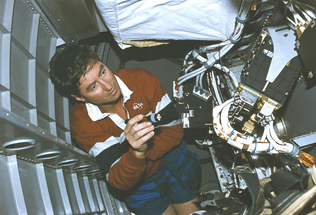 Launched on June 20, 1996, the STS-78 mission’s primary payload was the Life and Microgravity Spacelab (LMS), which was managed by the Marshall Space Flight Center (MSFC). During the 17 day space flight, the crew conducted a diverse slate of experiments divided into a mix of life science and microgravity investigations. In a manner very similar to future International Space Station operations, LMS researchers from the United States and their European counterparts shared resources such as crew time and equipment. Five space agencies (NASA/USA, European Space Agency/Europe (ESA), French Space Agency/France, Canadian Space Agency /Canada, and Italian Space Agency/Italy) along with research scientists from 10 countries worked together on the design, development and construction of the LMS. In this onboard photograph, mission commander Terence Henricks is checking out equipment.