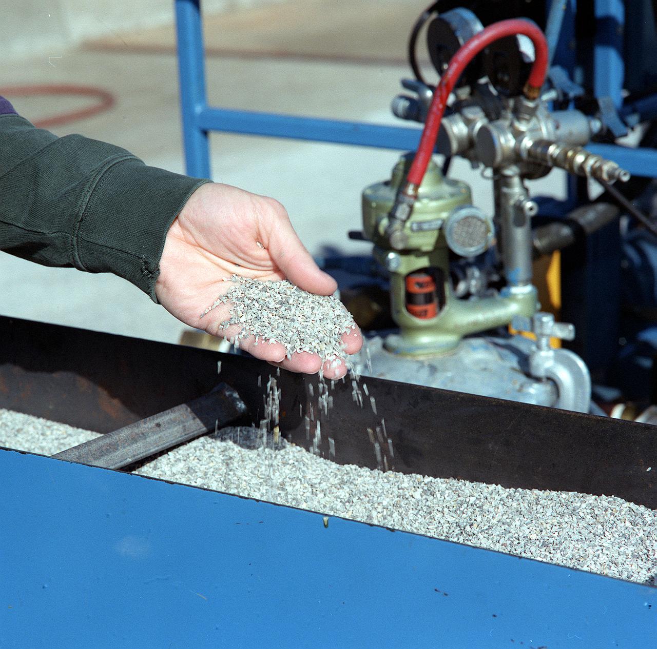 A workman inspects the results of Convergent Spray Technology used to resurface a bridge on Interstate 65 near Lacon, Alabama. Originally developed by USBI to apply a heat resistant coating to the Space Shuttle's Solid Rocket Boosters, the environment-friendly technology reduces the required worktime from days to hours.