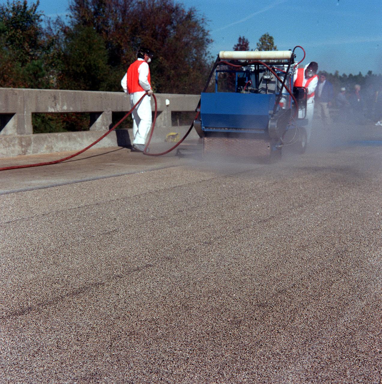 Alabama Department of Transportation workers utilize Convergent Spray Technology used to resurface a bridge on Interstate 65 near Lacon, Alabama. Originally developed by USBI to apply a heat resistant coating to the Space Shuttle's Solid Rocket Boosters, the environment-friendly technology reduces the required worktime from days to hours.