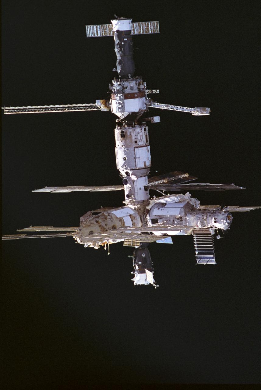 This image of the Russian Mir Space Station was photographed by a crewmember of the STS-74 mission when the Orbiter Atlantis was approaching the Mir Space Station. STS-74 was the second Space Shuttle/Mir docking mission. The Docking Module was delivered and installed, making it possible for the Space Shuttle to dock easily with Mir. The Orbiter Atlantis delivered water, supplies, and equipment, including two new solar arrays to upgrade the Mir, and returned to Earth with experiment samples, equipment for repair and analysis, and products manufactured on the Station. Mir was constructed in orbit by cornecting different modules, seperately launched from 1986 to 1996, providing a large and livable scientific laboratory in space. The 100-ton Mir was as big as six school buses and commonly housed three crewmembers. Mir was continuously occupied, except for two short periods, and hosted international scientists and American astronauts until August 1999. The journey of the 15-year-old Russian Mir Space Station ended March 23, 2001, as Mir re-entered the Earth's atmosphere and fell into the south Pacific ocean . STS-74 was launched on November 12, 1995, and landed at the Kennedy Space Center on November 20, 1995.