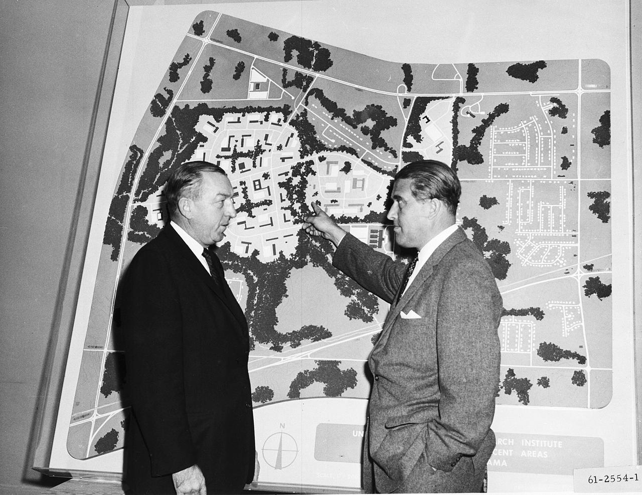 This 1961 photograph shows Dr. von Braun and Alabama Congressman Robert Jones before a huge map illustrating the layout for a Research Institute at the University of Alabama in Huntsville.