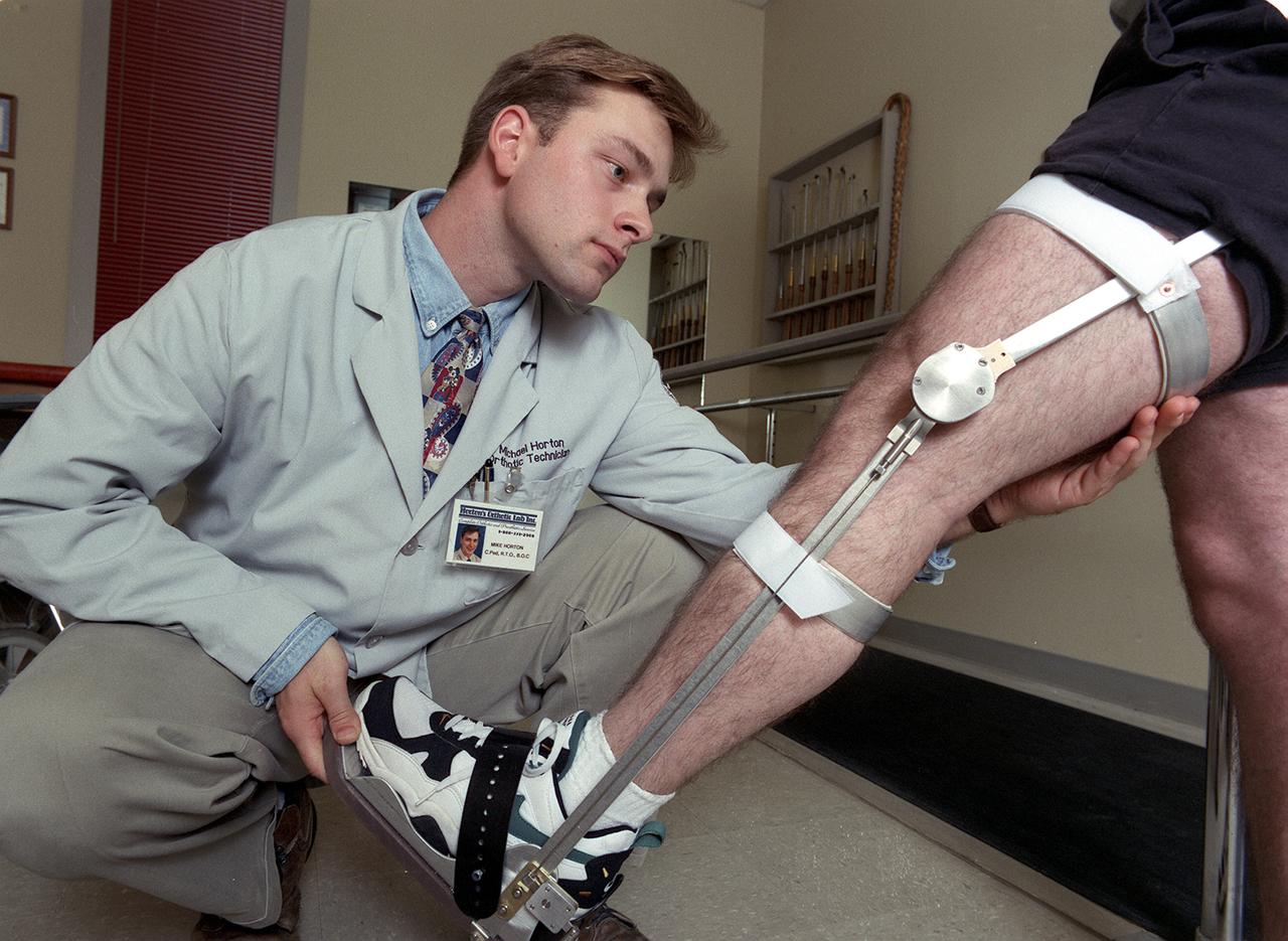 A knee brace that uses Space Shuttle propulsion technology has moved a step closer to being available to help knee injury and stroke patients and may possibly benefit patients with birth defects, spinal cord injuries, and post-polio conditions. After years of hard work, inventors at NASA's Marshall Space Flight Center (MSFC) in Huntsville, Alabama, have turned over the final design and prototype to industry partners at Horton's Orthotic Lab in Little Rock, Arkansas for further clinical testing. The device, called the Selectively Lockable Knee Brace, may mean faster, less painful rehabilitation for patients by allowing the knee to move when weight is not on the heel. Devices currently on the market lock the knee in a rigid, straight-leg position, or allow continuous free motion. Pictured here is a knee brace prototype being tested and fitted at Horton's Orthotic Lab. The knee brace is just one example of how space technology is being used to improve the lives of people on Earth. NASA's MSFC inventors Michael Shadoan and Neill Myers are space propulsion engineers who use the same mechanisms and materials to build systems for rockets that they used to design and develop the knee brace.