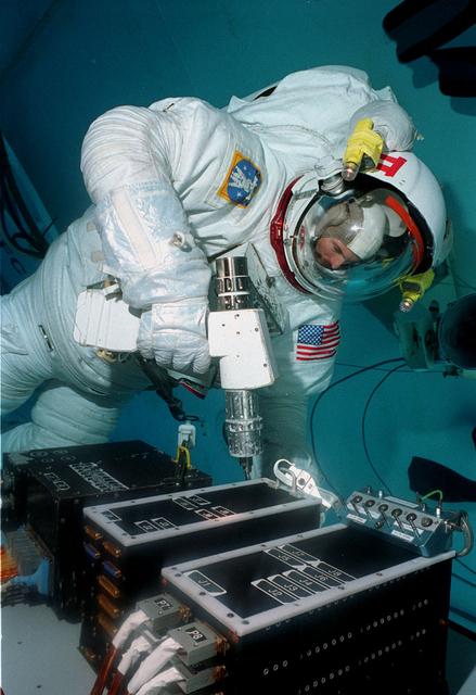 Astronaut Mark Lee conducts Hubble Space Telescope training in Marshall's Neutral Buoyancy Simulator (NBS)