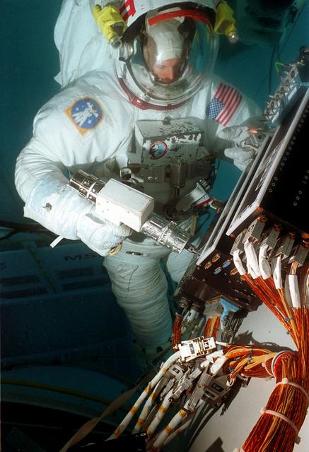 Astronaut Mark Lee conducts Hubble Space Telescope training in Marshall's Neutral Buoyancy Simulator (NBS)
