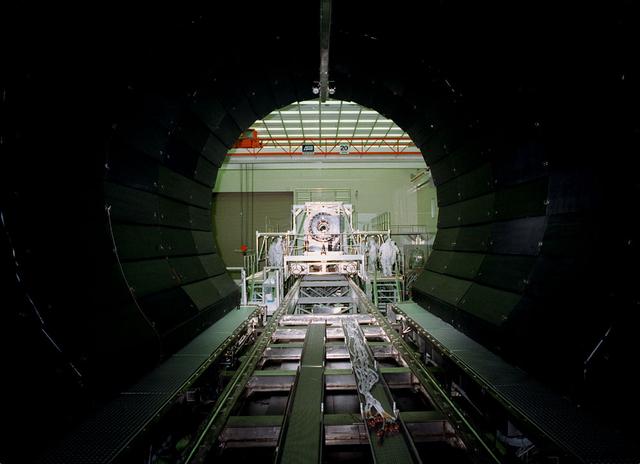 This is a photograph of the Chandra X-Ray Observatory (CXO), formerly Advanced X-Ray Astrophysics Facility (AXAF), High Resolution Mirror Assembly (HRMA) integration at the X-Ray Calibration Facility (XRCF) at the Marshall Space Flight Center (MSFC). The AXAF was renamed CXO in 1999. The CXO is the most sophisticated and the world's most powerful x-ray telescope ever built. It observes x-rays from high-energy regions of the universe, such as hot gas in the remnants of exploded stars. The HRMA, the heart of the telescope system, is contained in the cylindrical "telescope" portion of the observatory. Since high-energy x-rays would penetrate a normal mirror, special cylindrical mirrors were created. The two sets of four nested mirrors resemble tubes within tubes. Incoming x-rays graze off the highly polished mirror surface and are furneled to the instrument section for detection and study. MSFC's XRCF is the world's largest, most advanced laboratory for simulating x-ray emissions from distant celestial objects. It produces a space-like environment in which components related to x-ray telescope imaging are tested and the quality of their performances in space is predicted. TRW, Inc. was the prime contractor for the development of the CXO and NASA's MSCF was responsible for its project management. The Smithsonian Astrophysical Observatory controls science and flight operations of the CXO for NASA from Cambridge, Massachusetts. The CXO was launched July 22, 1999 aboard the Space Shuttle Columbia (STS-93).