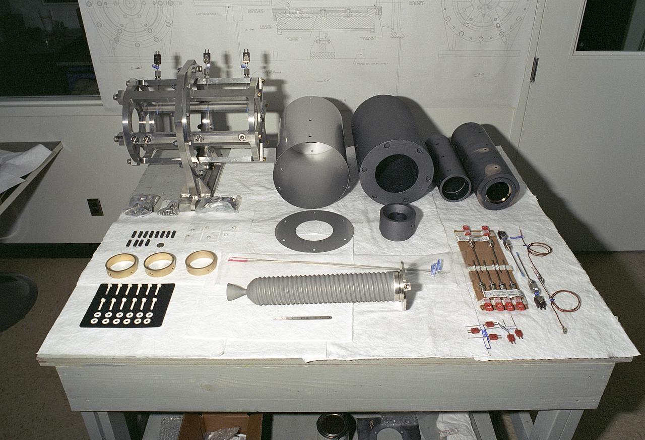 Researchers at the Marshall Space Flight Center (MSFC) have designed, fabricated, and tested the first solar thermal engine, a non-chemical rocket engine that produces lower thrust but has better thrust efficiency than a chemical combustion engine. This photograph shows components for the thermal propulsion engine being laid out prior to assembly. MSFC turned to solar thermal propulsion in the early 1990s due to its simplicity, safety, low cost, and commonality with other propulsion systems. As part of MSFC's Space Transportation Directorate, the Propulsion Research Center serves as a national resource for research of advanced, revolutionary propulsion technologies. The mission is to move the Nation's capabilities beyond the confines of conventional chemical propulsion into an era of aircraft-like access to Earth-orbit, rapid travel throughout the solar system, and exploration of interstellar space.