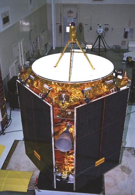 The Near Earth Asteroid Rendezvous (NEAR) spacecraft undergoing preflight preparation in the Spacecraft Assembly Encapsulation Facility-2 (SAEF-2) at Kennedy Space Center (KSC). NEAR will perform two critical mission events - Mathilde flyby and the Deep-Space maneuver. NEAR will fly-by Mathilde, a 38-mile (61-km) diameter C-type asteroid, making use of its imaging system to obtain useful optical navigation images. The primary science instrument will be the camera, but measurements of magnetic fields and mass also will be made. The Deep-Space Maneuver (DSM) will be executed about a week after the Mathilde fly-by. The DSM represents the first of two major burns during the NEAR mission of the 100-pound bi-propellant (Hydrazine/nitrogen tetroxide) thruster. This maneuver is necessary to lower the perihelion distance of NEAR's trajectory. The DSM will be conducted in two segments to minimize the possibility of an overburn situation.