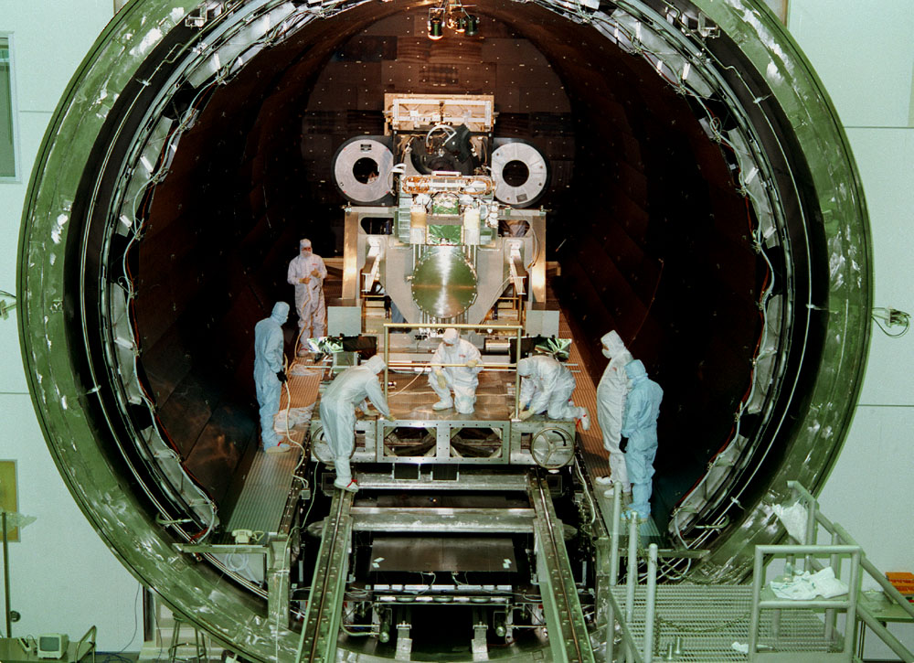 This photo shows the High Resolution Camera (HRC) for the Chandra X-Ray Observatory (CXO), formerly Advanced X-Ray Astrophysics Facility (AXAF), being integrated with the High Resolution Mirror Assembly (HRMA) in Marshall Space Flight Center's (MSFC's) 24-foot Vacuum Chamber at the X-Ray Calibration Facility (XRCF). The AXAF was renamed CXO in 1999. The CXO is the most sophisticated and the world's most poweful x-ray telescope ever built. It observes x-rays from high-energy regions of the universe, such as hot gas in the remnants of exploded stars. The HRC is one of the two instruments used at the focus of CXO, where it will detect x-rays reflected from an assembly of eight mirrors. The unique capabilities of the HRC stem from the close match of its imaging capability to the focusing of the mirrors. When used with CXO mirrors, the HRC makes images that reveal detail as small as one-half an arc second. This is equivalent to the ability to read a newspaper at a distance of 1 kilometer. MSFC's XRCF is the world's largest, most advanced laboratory for simulating x-ray emissions from distant celestial objects. It produces a space-like environment in which components relatedto x-ray telescope imaging are tested and the quality of their performances in space is predicted. TRW, Inc. was the prime contractor for the development of the CXO and NASA's MSFC was responsible for its project management. The Smithsonian Astrophysical Observatory controls science and flight operations of the CXO for NASA from Cambridge, Massachusetts. The CXO was launched July 22, 1999 aboard the Space Shuttle Columbia (STS-93).