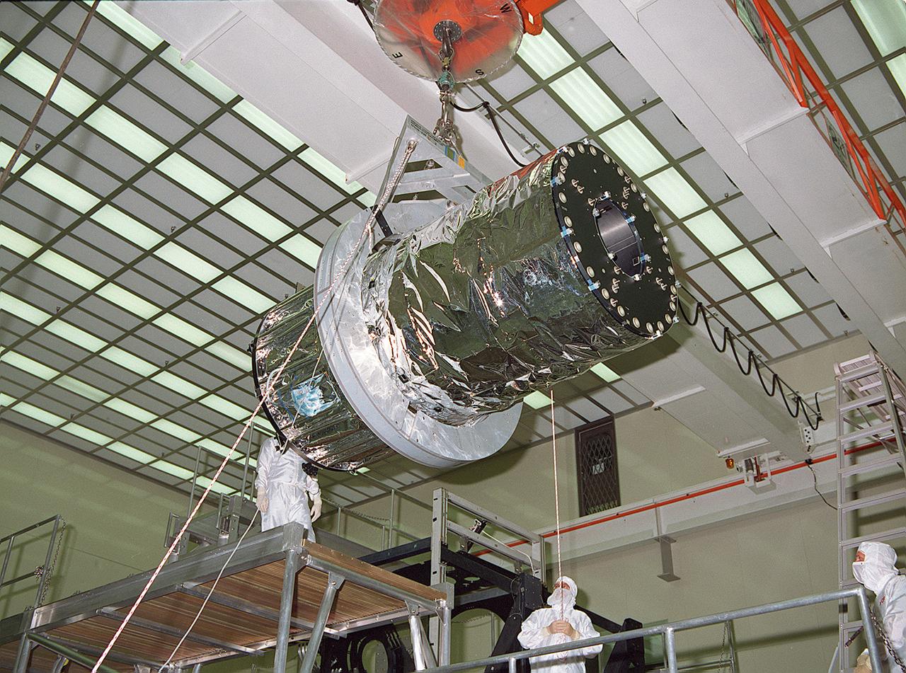 This photograph shows the Chandra X-ray Observatory (CXO), formerly Advanced X-Ray Astrophysics Facility (AXAF), High Resolution Mirror Assembly (HRMA) being removed from the test structure in the X-Ray Calibration Facility (XRCF) at the Marshall Space Flight Center (MSFC). The AXAF was renamed CXO in 1999. The CXO is the most sophisticated and the world's most powerful x-ray telescope ever built. It observes x-rays from high-energy regions of the universe, such as hot gas in the remnants of exploded stars. The HRMA, the heart of the telescope system, is contained in the cylindrical "telescope" portion of the observatory. Since high-energy x-rays would penetrate a normal mirror, special cylindrical mirrors were created. The two sets of four nested mirrors resemble tubes within tubes. Incoming x-rays graze off the highly polished mirror surface and are furneled to the instrument section for detection and study. MSFC's XRCF is the world's largest, most advanced laboratory for simulating x-ray emissions from distant celestial objects. It produces a space-like environment in which components related to x-ray telescope imaging are tested and the quality of their performances in space is predicted. TRW, Inc. was the prime contractor for the development of the CXO and NASA's MSFC was responsible for its project management. The Smithsonian Astrophysical Observatory controls science and flight operations of the CXO for NASA from Cambridge, Massachusetts. The CXO was launched July 22, 1999 aboard the Space Shuttle Columbia (STS-93).