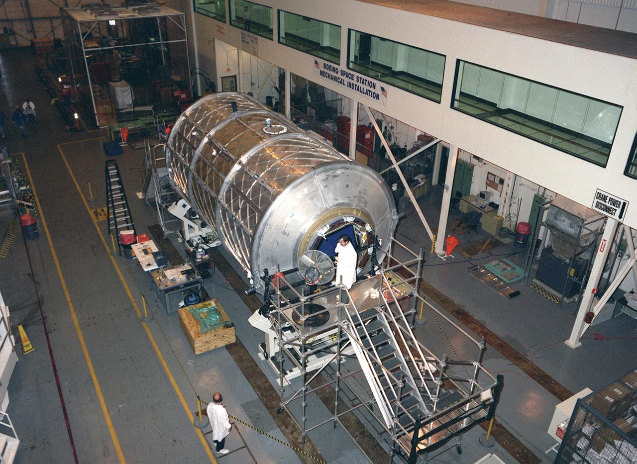 In this photograph, the U.S. Laboratory Module (also called Destiny) for the International Space Station (ISS) is shown under construction in the West High Bay of the Space Station manufacturing facility (building 4708) at the Marshall Space Flight Center. The U.S. Laboratory module is the centerpiece of the ISS, where science experiments will be performed in the near-zero gravity of space. The Destiny Module was launched aboard the Space Shuttle orbiter Atlantis (STS-98 mission) on February 7, 2001. The aluminum module is 8.5 meters (28 feet) long and 4.3 meters (14 feet) in diameter. The laboratory consists of three cylindrical sections and two endcones with hatches that will be mated to other station components. A 50.9-centimeter- (20-inch-) diameter window is located on one side of the center module segment. This pressurized module is designed to accommodate pressurized payloads. It has a capacity of 24 rack locations, and payload racks will occupy 13 locations especially designed to support experiments. The ISS is a multidisciplinary laboratory, technology test bed, and observatory that will provide unprecedented undertakings in scientific, technological, and international experimentation.