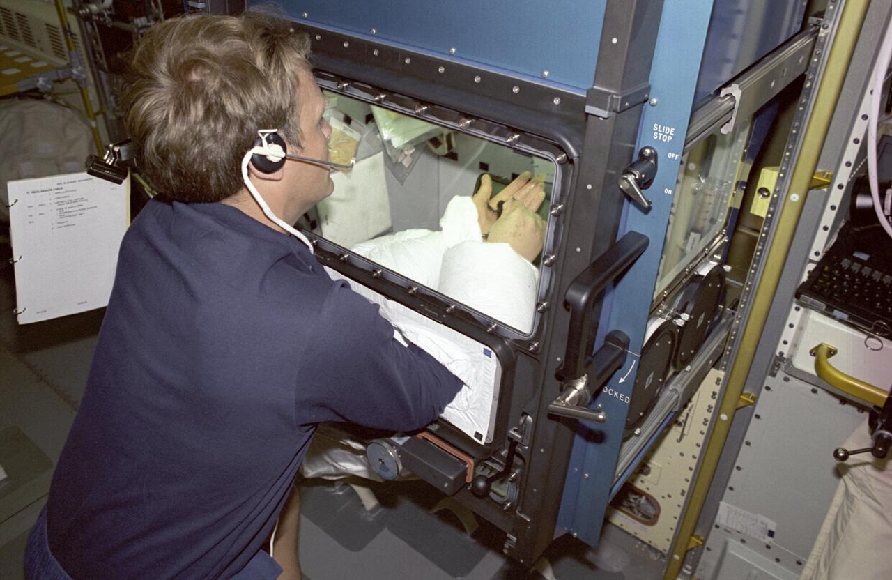 The Spacelab-J (SL-J) mission was a joint venture between NASA and the National Space Development Agency of Japan (NASDA) utilizing a marned Spacelab module. Materials science investigations covered such fields as biotechnology, electronic materials, fluid dynamics and transport phenomena, glasses and ceramics, metals and alloys, and acceleration measurements. Life sciences included experiments on human health, cell separation and biology, developmental biology, animal and human physiology and behavior, space radiation, and biological rhythms. Before long-term space ventures are attempted, numerous questions must be answered: how will gravity play in the early development of an organism, and how will new generations of a species be conceived and develop normally in microgravity. The Effects of Weightlessness on the Development of Amphibian Eggs Fertilized in Space experiment aboard SL-J examined aspects of these questions. To investigate the effect of microgravity on amphibian development, female frogs carried aboard SL-J were induced to ovulate and shed eggs. These eggs were then fertilized in the microgravity environment. Half were incubated in microgravity, while the other half were incubated in a centrifuge that spins to simulate normal gravity. This photograph shows astronaut Mark Lee working with one of the adult female frogs inside the incubator. The mission also examined the swimming behavior of tadpoles grown in the absence of gravity. The Spacelab-J was launched aboard the Space Shuttle Orbiter Endeavour on September 12, 1992.