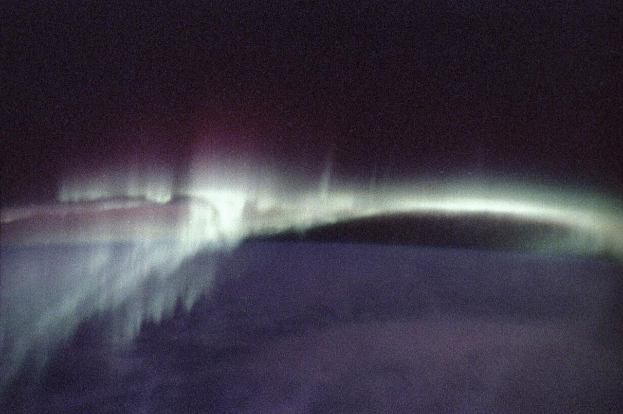 This photograph of aurora borealis, northern aurora, was taken during the Spacelab-J (SL-J) mission (STS-47). People who live in the northernmost areas like Alaska or work in the southernmost regions like Antarctica often see colorful lights produced by Earth's natural electromagnetic generator; these shimmering expanses of light are auroras, commonly called the northern and southern lights. Charged particles from the magnetosphere follow magnetic fields and are accelerated toward Earth at the magnetic poles where they strike molecules in the upper atmosphere, staining the sky with the red and green lights of oxygen and hydrogen, and the purples and pinks of nitrogen. The altitude and inclination of the Spacelab will give scientists unique views of auroras, which occur at altitudes ranging from about 90 to 300 kilometers (56 to 186 miles). Most views of the auroras have been from the ground where only limited parts can be seen. These Skylab views will give scientists information on their complex structure and chemical composition. The Spacelab-J was a joint mission of NASA and the National Space Development Agency of Japan (NASDA) utilizing a marned Spacelab module. The mission conducted microgravity investigations in materials and life sciences. The SL-J was launched aboard the Space Shuttle Orbiter Endeavour (STS-47) on September 12, 1992.