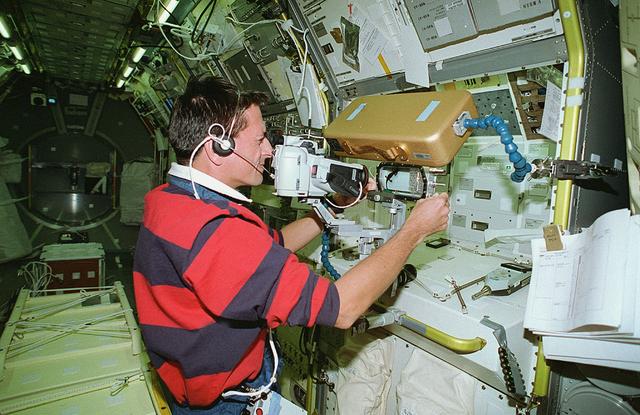 Astronaut Donald Thomas conducts the Fertilization and Embryonic Development of Japanese Newt in Space (AstroNewt) experiment at the Aquatic Animal Experiment Unit (AAEU) inside the International Microgravity Laboratory-2 (IML-2) science module. The AstroNewt experiment aims to know the effects of gravity on the early developmental process of fertilized eggs using a unique aquatic animal, the Japanese red-bellied newt. The newt egg is a large single cell at the begirning of development. The Japanese newt mates in spring and autumn. In late autumn, female newts enter hibernation with sperm in their body cavity and in spring lay eggs and fertilize them with the stored sperm. The experiment takes advantage of this feature of the newt. Groups of newts were sent to the Kennedy Space Center and kept in hibernation until the mission. The AAEU cassettes carried four newts aboard the Space Shuttle. Two newts in one cassette are treated by hormone injection on the ground to simulate egg laying. The other two newts are treated on orbit by the crew. The former group started maturization of eggs before launch. The effects of gravity on that early process were differentiated by comparison of the two groups. The IML-2 was the second in a series of Spacelab flights designed to conduct research by the international science community in a microgravity environment. Managed by the Marshall Space Flight Center, the IML-2 was launched on July 8, 1994 aboard the STS-65 Space Shuttle mission, Orbiter Columbia.