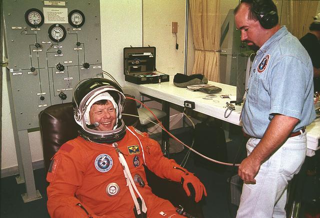 STS-94 Payload Specialist Roger K. Crouch is helped into his launch/entry suit by a suit technician in the Operations and Checkout (OC) building after the suit has been given a pressure test. He is the Chief Scientist of the NASA Microgravity Space and Applications Division. He also has served as a Program Scientist for previous missions and is an expert in semiconductor crystal growth. Crouch and six other crewmembers prepare to depart the OC and head for Launch Pad 39a, where the Space Shuttle Columbia will lift off. 