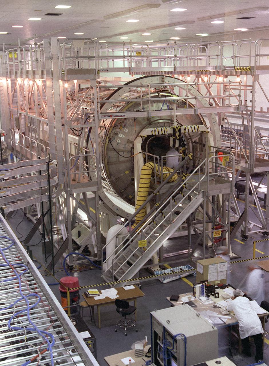 In this photograph, the U.S. Laboratory Module (also called Destiny) for the International Space Station (ISS) is shown under construction in the West High Bay of the Space Station manufacturing facility (building 4708) at the Marshall Space Flight Center. The U.S. Laboratory module is the centerpiece of the ISS, where science experiments will be performed in the near-zero gravity of space. The Destiny Module was launched aboard the Space Shuttle orbiter Atlantis (STS-98 mission) on February 7, 2001. The aluminum module is 8.5 meters (28 feet) long and 4.3 meters (14 feet) in diameter. The laboratory consists of three cylindrical sections and two endcones with hatches that will be mated to other station components. A 50.9-centimeter- (20-inch-) diameter window is located on one side of the center module segment. This pressurized module is designed to accommodate pressurized payloads. It has a capacity of 24 rack locations, and payload racks will occupy 13 locations especially designed to support experiments. The ISS is a multidisciplinary laboratory, technology test bed, and observatory that will provide unprecedented undertakings in scientific, technological, and international experimentation.