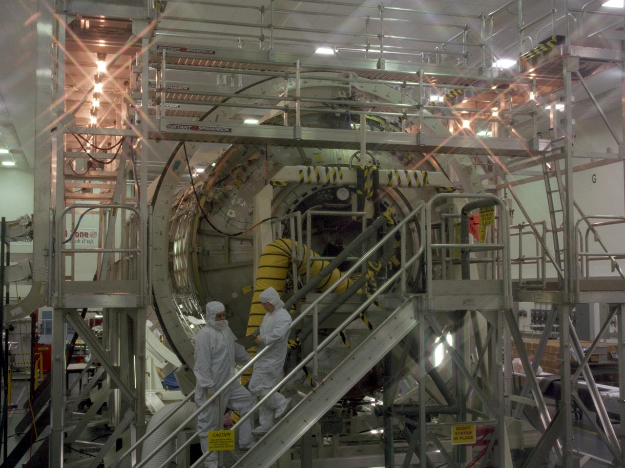 This photograph shows the U.S. Laboratory Module (also called Destiny) for the International Space Station (ISS), under construction in the Space Station manufacturing facility at the Marshall Space Flight Center. The U.S. Laboratory module is the centerpiece of the ISS, where science experiments will be performed in the near-zero gravity of space. The Destiny Module was launched aboard the Space Shuttle orbiter Atlantis (STS-67 mission) on February 7, 2001. The aluminum module is 8.5 meters (28 feet) long and 4.3 meters (14 feet) in diameter. The laboratory consists of three cylindrical sections and two end cones with hatches that will be mated to other station components. A 50.9-centimeter- (20-inch-) diameter window is located on one side of the center module segment. This pressurized module is designed to accommodate pressurized payloads. It has a capacity of 24 rack locations, and payload racks will occupy 13 locations especially designed to support experiments. The ISS is a multidisciplinary laboratory, technology test bed, and observatory that will provide unprecedented undertakings in scientific, technological, and international experimentation.