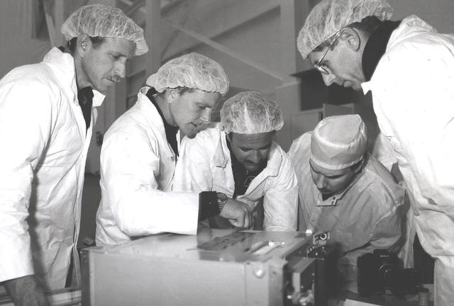 Space Shuttle Discovery (STS-26) astronauts George Nelson, John Lounge, and Richard Covey are pictured training on protein crystal growth (PCG) experiment in Marshall's Building 4708's clean room.