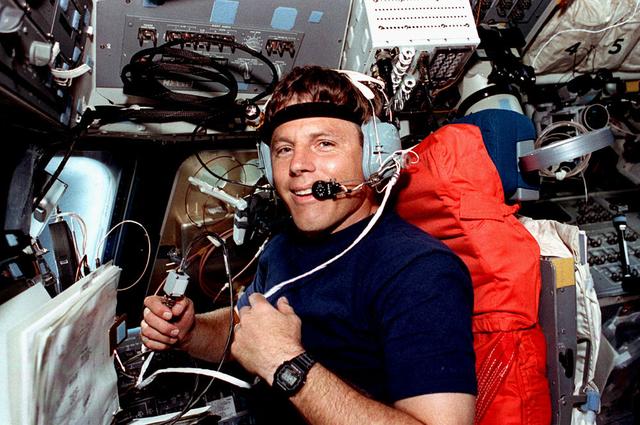 Space Shuttle Discovery (STS-56) onboard photo of Pilot Stephen S. Oswald (wearing a headset) uses the Shuttle Amateur Radio Experiment II (SAREX-II) while sitting at the pilot's station on the forward flight deck. Oswald smiled from behind the microphone as he talks to amateur radio operators on Earth via the SAREX equipment. SAREX cables and the interface module freefloat in front of Oswald. The anterna located in the forward flight deck window is visible in the background. SAREX was established by NASA, the American Radio League/Amateur Radio Satellite Corporation and the Johnson Space Center (JSC) Amateur Radio Club to encourage public participation in the space program through a program to demonstrate the effectiveness of conducting short-wave radio transmissions between the Shuttle and ground-based radio operators at low-cost ground stations with amateur and digital techniques.