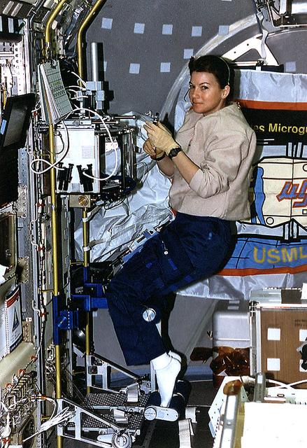 Onboard Space Shuttle Columbia (STS-73) Mission Specialists Catherine Cady Coleman works at the glovebox facility in support of the Protein Crystal Growth Glovebox (PCG-GBX) experiment in the United States Microgravity Laboratory 2 (USML-2) Spacelab science module.