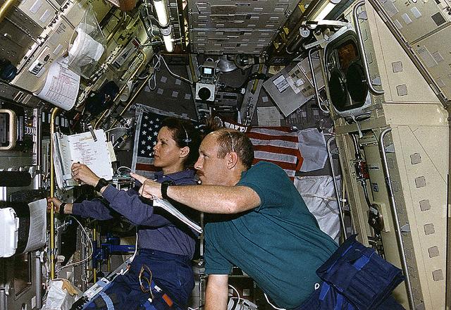 Onboard Space Shuttle Columbia (STS-73) Payload Commander Kathryn Thornton and Commander Ken Bowersox discuss the Drop Physics Module (DPM) experiment in the United States Microgravity Laboratory 2 (USML-2) spacelab science module.