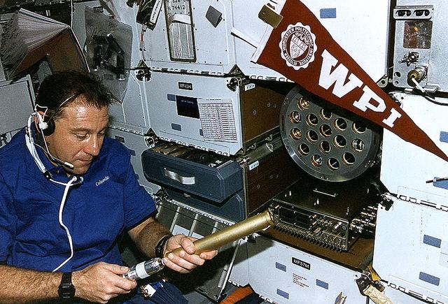 Onboard Space Shuttle Columbia (STS-73) Payload Specialist Albert Sacco loads autoclaves using a power screwdriver into the Zeolite Crystal Growth (ZCG) experiment in the middeck for the United States Microgravity Laboratory 2 (USML-2) Spacelab mission.
