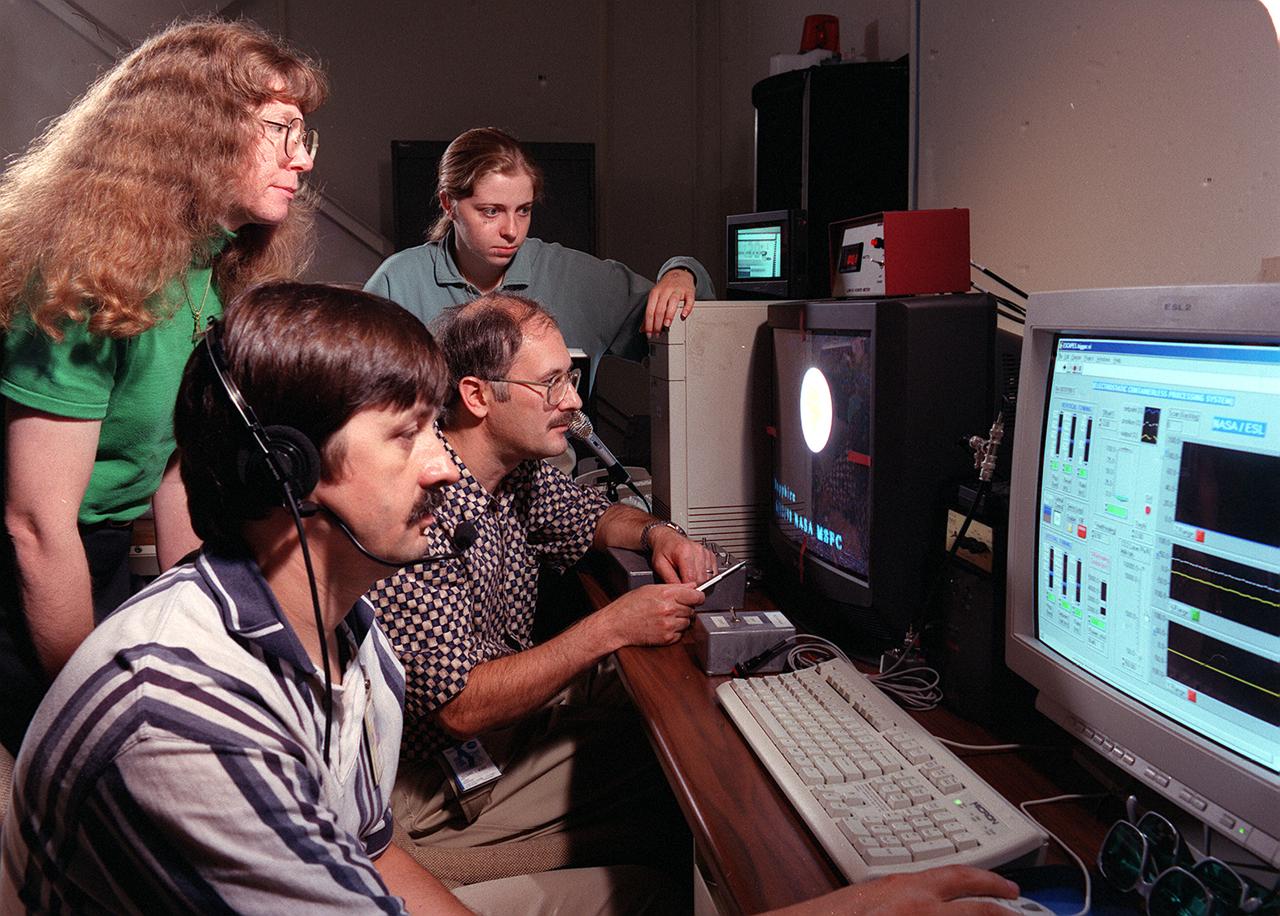 Dr. Jan Rogers (left) and Larry Savage (foreground) of the Science Directorate at NASA's Marshall Space Flight Center (MSFC) are joined by Dr. Richard Weber (center) and April Hixon of Containerless Research Inc. of Evanston, Ill., in conducting an experiment run of the Electrostatic Levitator (ESL) using insulating materials. Materials researchers use unique capabilities of the facility to levitate and study the properties of various materials important in manufacturing processes.