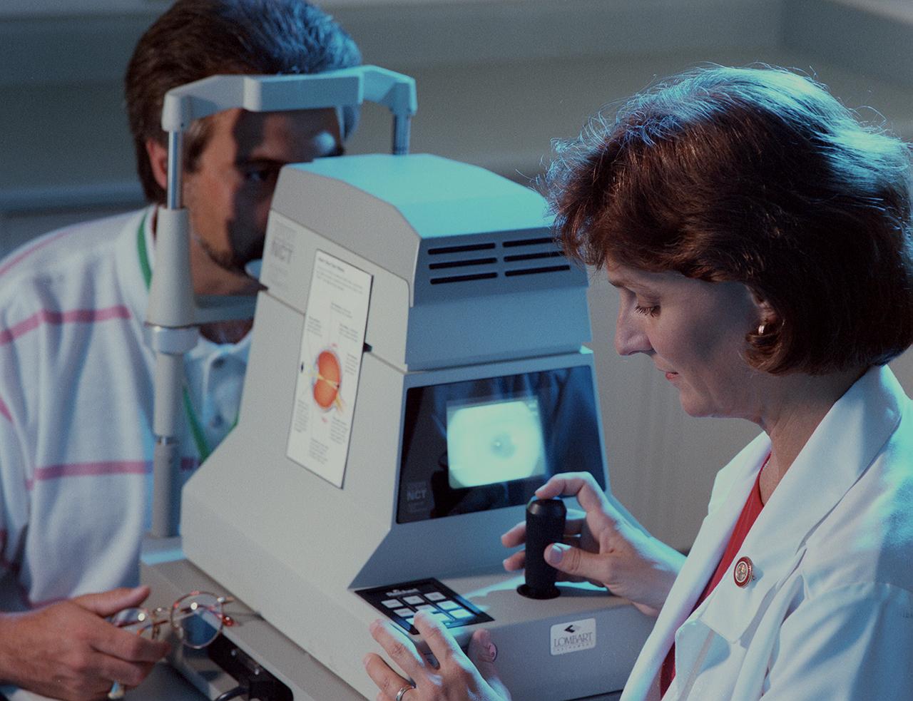 Nurse performs tonometry examination, which measure the tension of the eyeball, during an employee's arnual physical examination given by MSFC Occupational Medicine Environmental Health Services under the Center Operations Directorate.