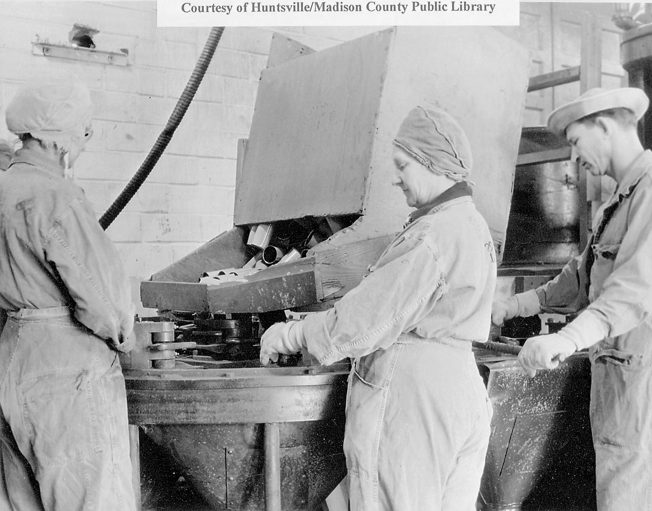 During World War II, Arsenal workers from Huntsville, Alabama. and surrounding areas responded to the call for civilian defense workers. This February 20, 1945 photo shows workers filling colored smoke grenades that were used for signaling. (Courtesy of Huntsville/Madison County Public Library)