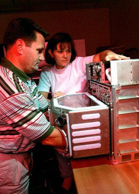 Mary-Etta Wright and Dornie McCaghren with Russia's Mir Flight Glovebox.