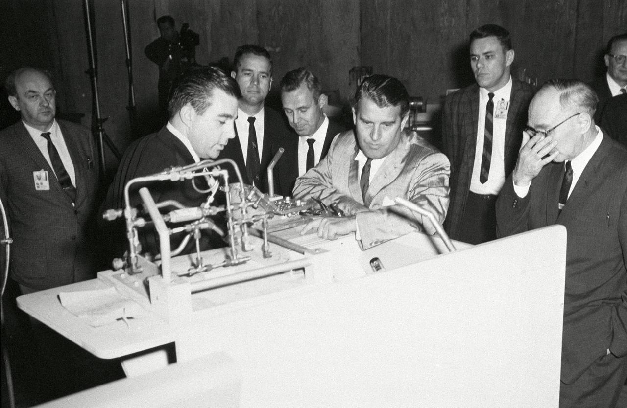 During his tenure as Director of the Marshall Space Flight Center (MSFC), Dr. von Braun enjoyed personally touring the Center's many space-related laboratories and facilities. This photo taken about 1961 shows him examining a test set up in the Center's Manufacturing Engineering Laboratory.