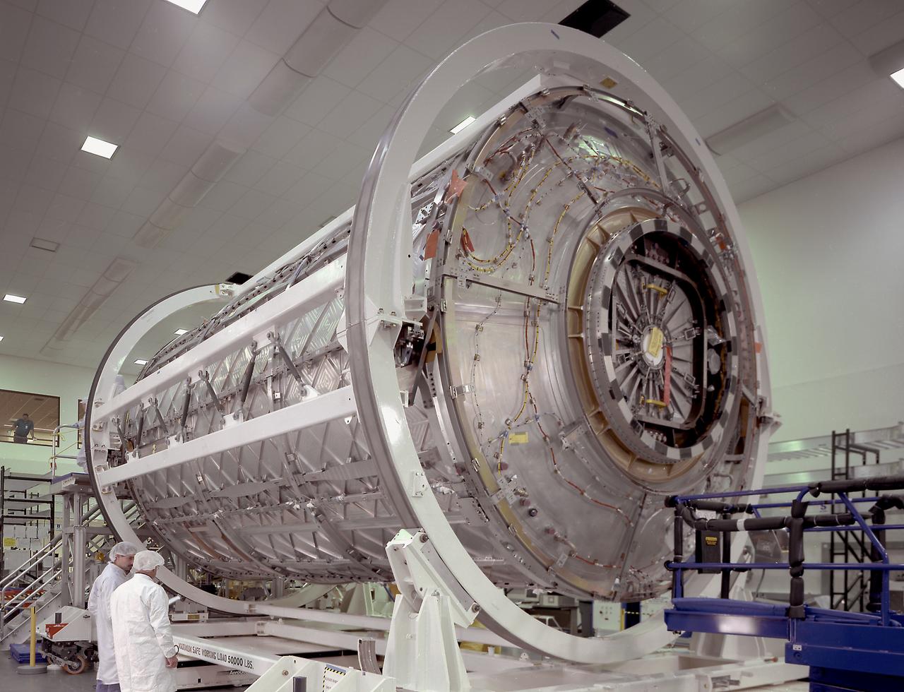 This photograph shows the U.S. Laboratory Module (also called Destiny) for the International Space Station (ISS), in the Space Station manufacturing facility at the Marshall Space Flight Center, being readied for shipment to the Kennedy Space Center. The U.S. Laboratory module is the centerpiece of the ISS, where science experiments will be performed in the near-zero gravity of space. The Destiny Module was launched aboard the Space Shuttle orbiter Atlantis (STS-67 mission) on February 7, 2001. The aluminum module is 8.5 meters (28 feet) long and 4.3 meters (14 feet) in diameter. The laboratory consists of three cylindrical sections and two endcones with hatches that will be mated to other station components. A 50.9-centimeter- (20-inch-) diameter window is located on one side of the center module segment. This pressurized module is designed to accommodate pressurized payloads. It has a capacity of 24 rack locations, and payload racks will occupy 13 locations especially designed to support experiments. The ISS is a multidisciplinary laboratory, technology test bed, and observatory that will provide unprecedented undertakings in scientific, technological, and international experimentation.