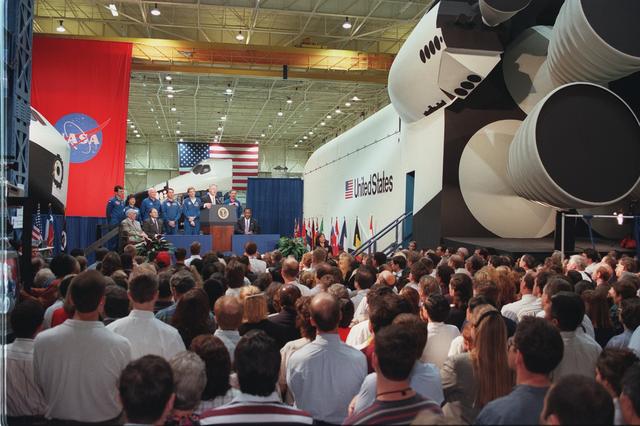 S98-05023 (14 April 1998) --- A large crowd of JSC employees listen to President Bill Clinton during an April 14 visit to the Johnson Space Center. NASA, Houston and JSC officials, as well as the STS-95 Discovery crew members scheduled to fly in space later this year, are on the dais with the President. He earlier had gone inside several of the Shuttle and ISS crew training facilities and mockups. Photo Credit: Joe McNally, National Geographic, for NASA