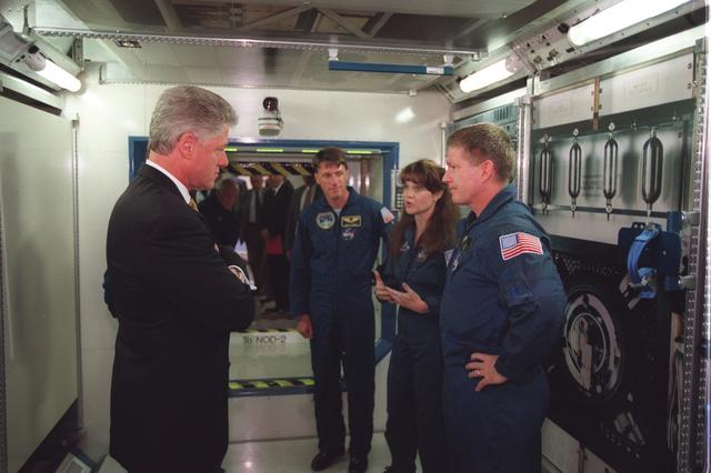 S98-05025 (14 April 1998) --- President Bill Clinton tours a laboratory mockup used for training purposes by astronauts assigned to fly aboard the International Space Station (ISS). Astronaut William Shepherd (right), mission commander for the first ISS expedition crew, briefs the Chief Executive. Looking on are astronauts C. Michael Foale and Tamara C. Jernigan. Foale spent four months last year aboard Russia's Mir space station. President Clinton toured several mockups and other training components before speaking to a crowd of JSC employees.    Photo Credit:  Joe McNally, National Geographic, for NASA