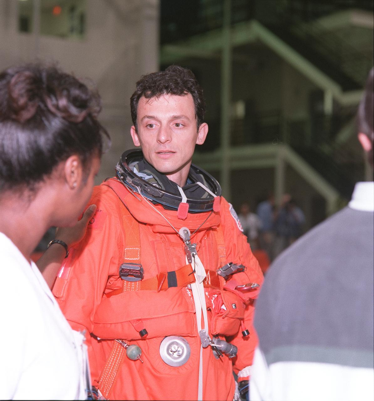 S98-07974 (5 June 1998) --- Astronaut Pedro Duque, STS-95 mission specialist representing the European Space Agency (ESA), is assisted by suit technician Sharon McDougle in final touches with his shuttle launch and entry suit. The crew for the scheduled late October, early November mission was participating in a lengthy training session in the Johnson Space Center's systems integration facility.