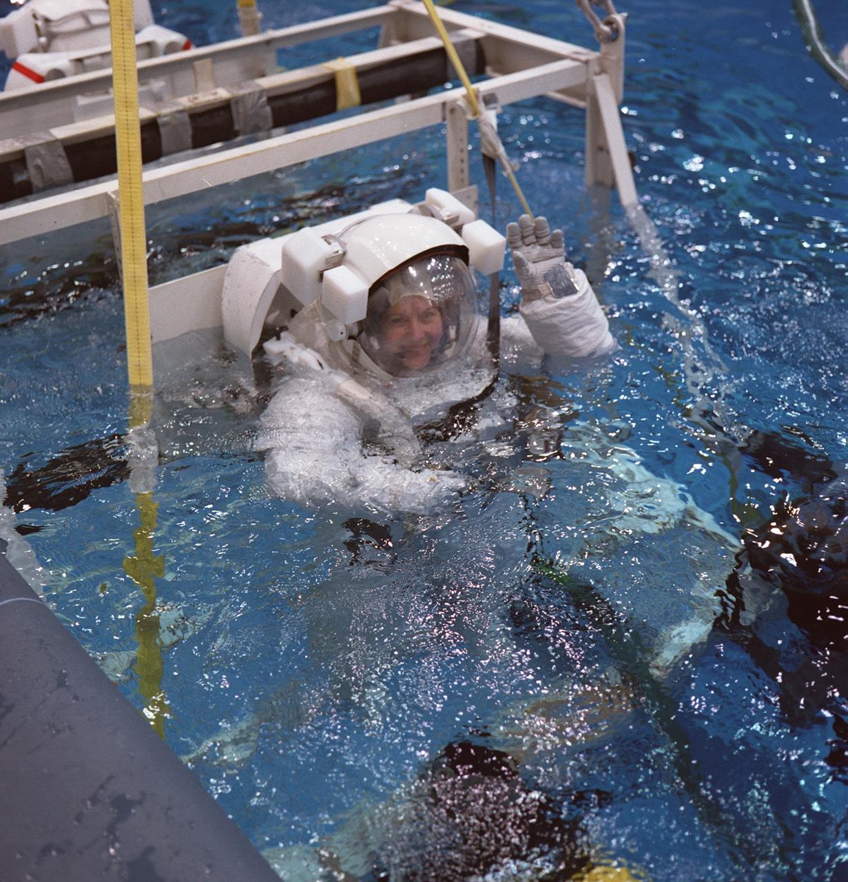 S98-08181 (March 1998) --- Standing on a mobile platform, astronaut Catherine G. Coleman is in the processing of being submerged in the deep pool of  JSC's Neutral Buoyancy Laboratory (NBL).  Coleman was participating in a simulation of a contingency space walk  in preparation for the STS-93 mission next year. The mission specialist   will join four other NASA astronauts for the Space Shuttle Columbia flight, scheduled for spring.  The training version of the extravehicular mobility unit (EMU) that Coleman is wearing is  weighted and otherwise accommodated to afford neutral buoyancy in the deep pool.