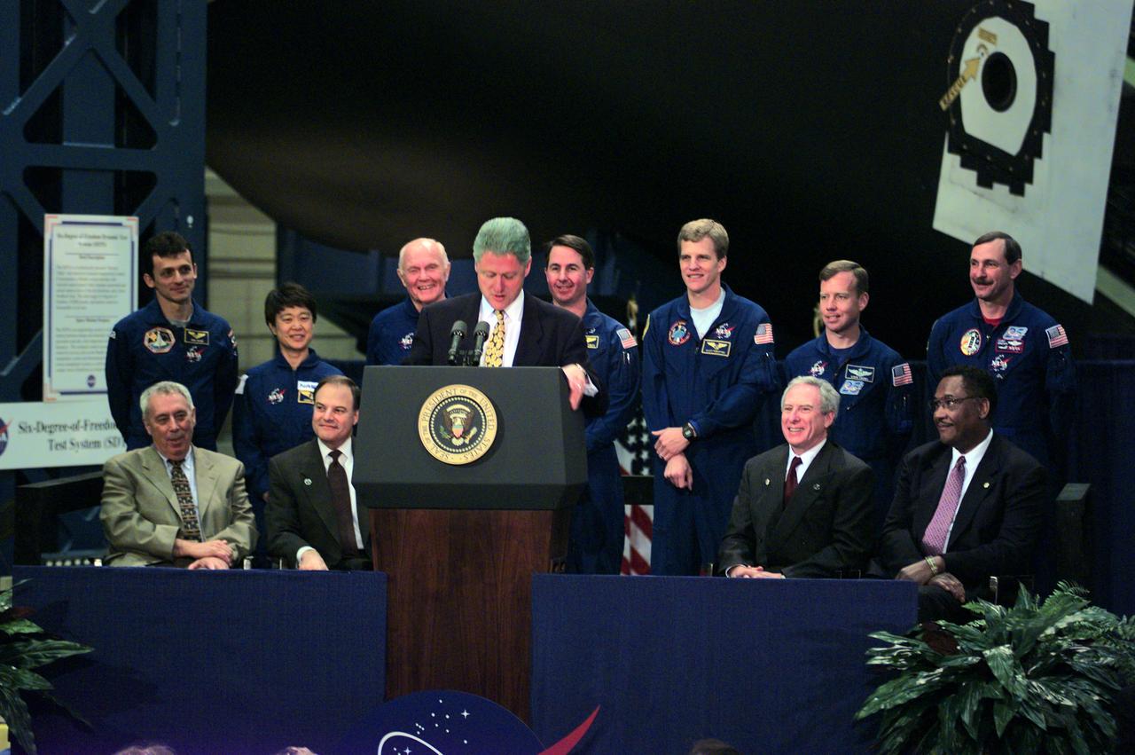 98-E-03312 (14 April 1998) --- President Bill Clinton (at lectern) addresses employees at NASA's Johnson Space Center (JSC) during an April 14 visit to the Houston facility. Seated behind him (from the left) are JSC Director George W.S. Abbey, U.S. Rep. Nick Lampson (D.-TX), NASA Administrator Daniel Goldin and Houston Mayor Lee Brown. Standing are members of the STS-95 crew: (from the left) Pedro Duque, Chiaki Mukai, U.S. Sen. John H. Glenn Jr. (D.-Ohio), Stephen K. Robinson, Scott E. Parazynski, Steven W. Lindsey and Curtis L. Brown Jr. Brown is commander of the scheduled flight aboard Discovery. Mukai represents Japan's National Space Development Agency (NASDA) and Duque is with the European Space Agency (ESA). Photo Credit: NASA or the National Aeronautics and Space Administration.