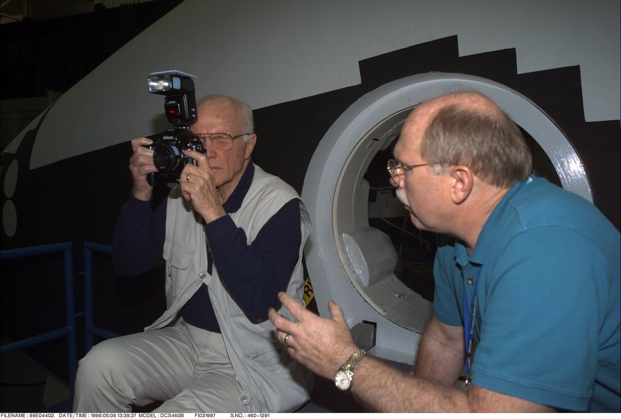 98-E-04402 (8 May 1998) --- Photo/TV instructor Donald Carico, right, goes over some fine points of using a 35mm camera with U.S. Sen. John H. Glenn Jr., (D.-Ohio). Glenn, who made America's first orbital flight over 36 years ago, is in Houston to train for his assignment as a payload specialist aboard the Space Shuttle Discovery later this year.