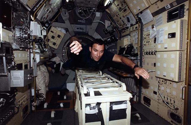 Astronaut Carl E. Walz, mission specialist, enters the International Microgravity Laboratory (IML-2) science module in the cargo bay via the turnel connecting it to Columbia's cabin. Walz joined five other NASA astronauts and a Japanese payload specialist for more than two weeks of experimenting in Earth orbit.
