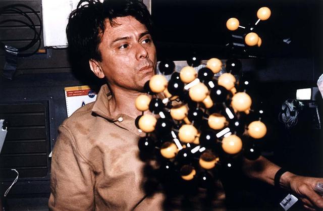 Astronaut Franklin R. Chang-Diaz, payload commander, ponders the elements of a model representing the Commercial Protein Crystal Growth (CPCG) experiment. This flight of the experiment marks the first joint United States--Latin America effort in this discipline. The project brings together a small team of investigators from Costa Rica (Chang-Diaz's native land), Chile, and the United States.