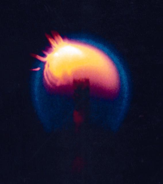 This photograph from CFM shows a candle flame burning over time in microgravity, it shows pieces of wax or soot moving through the flame about 25 seconds after ignition.