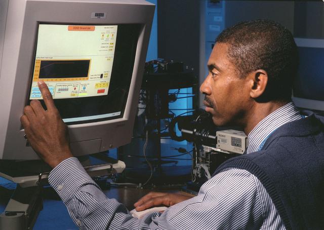The Equiaxed Dendritic Solidification Experiment (EDSE) is a material sciences investigation under the Formation of Microstructures/pattern formation discipline. The objective is to study the microstructural evolution of and thermal interactions between several quiaxed crystals growing dendritically in a supercooled melt of a pure and transparent substance under diffusion controlled conditions. George Myers, controls engineer, monitors the thermal environment of a ground test for the EDSE located in the Microgravity Development Laboratory (MDL).