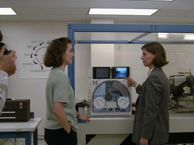University of Alabama engineer Stacey Giles briefs NASA astronaut Dr. Bornie Dunbar about the design and capabilities of the X-ray Crystallography Facility under development at the Center for Macromolecular Crystallography of the University of Alabama at Birmingham, AL, April 21, 1999. The X-ray Crystallography Facility is designed to speed the collection of protein structure information from crystals grown aboard the International Space Station. By measuring and mapping the protein crystal structure in space, researchers will avoid exposing the delicate crystals to the rigors of space travel and make important research data available to scientists much faster. The X-ray Crystallography facility is being designed and developed by the Center for Macromolecular Crystallography of the University of Alabama at Birmingham, a NASA Commercial Space Center.