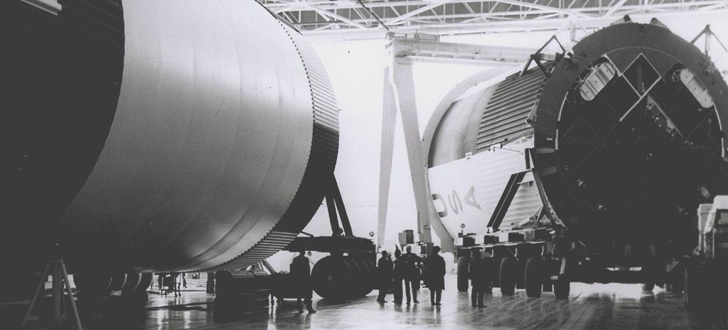 This photograph shows the Saturn V assembled LOX (Liquid Oxygen) and fuel tanks ready for transport from the Manufacturing Engineering Laboratory at Marshall Space Flight Center in Huntsville, Alabama. The tanks were then shipped to the launch site at Kennedy Space Center for a flight. The towering 363-foot Saturn V was a multi-stage, multi-engine launch vehicle standing taller than the Statue of Liberty. Altogether, the Saturn V engines produced as much power as 85 Hoover Dams. 
