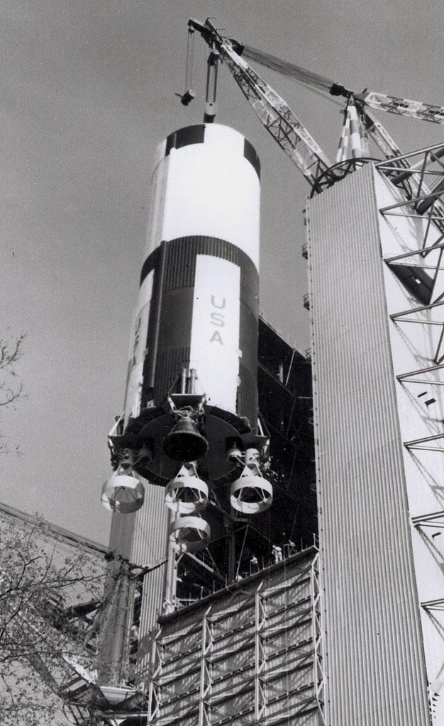 This photo shows the Saturn V first stage being lowered to the ground following a successful test to determine the effects of continual vibrations simulating the effects of an actual launch. The towering 363-foot Saturn V was a multi-stage, multi-engine launch vehicle standing taller than the Statue of Liberty. Altogether, the Saturn V engines produced as much power as 85 Hoover Dams.
