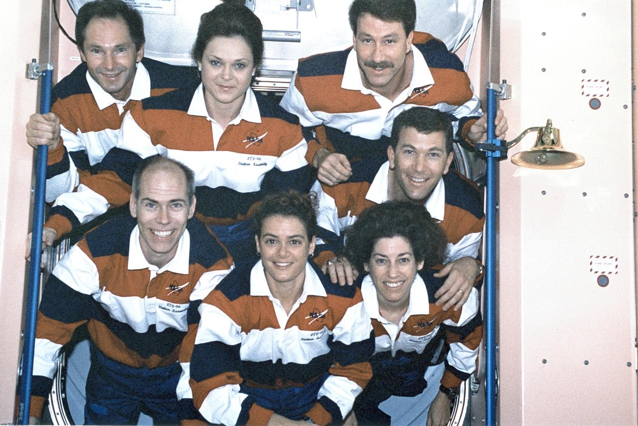 The STS-96 crew paused for an International Space Station (ISS) onboard group photo. Pictured on the bottom row (left to right) are Mission Specialists Daniel Barry, Julie Payette, and Ellen Ochoa. Pictured on the top row (left to right) are Cosmonaut Valery Ivanovich Tokarev, and Tamara Jernigan, Mission Specialists; Kent Rominger, Commander; and Rick Husband, Pilot. STS-96 was the second ISS assembly flight and the first flight to dock with the station. The 10 day mission crew launched aboard the Space Shuttle Orbiter Discovery on May 27, 1999.