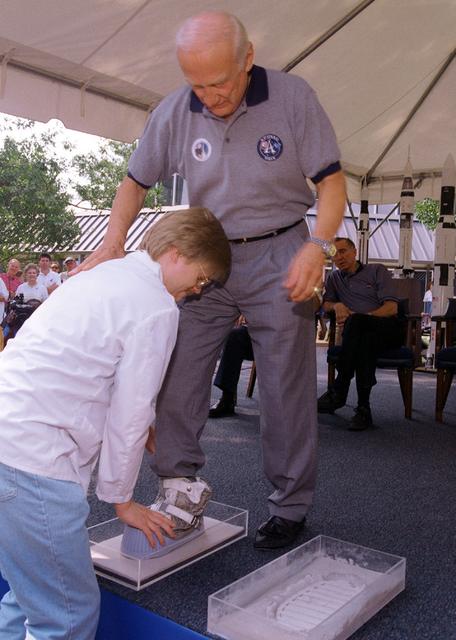 Apollo 11 Astronaut Buzz Aldrin has his footprints casted during the dedication ceremony of the rocket fountain at Building 4200 at Marshall Space Flight Center. The casts of Aldrin's footprints will be placed in the newly constructed Von Braun courtyard representing the accomplishments of the Apollo 11 lunar landing.