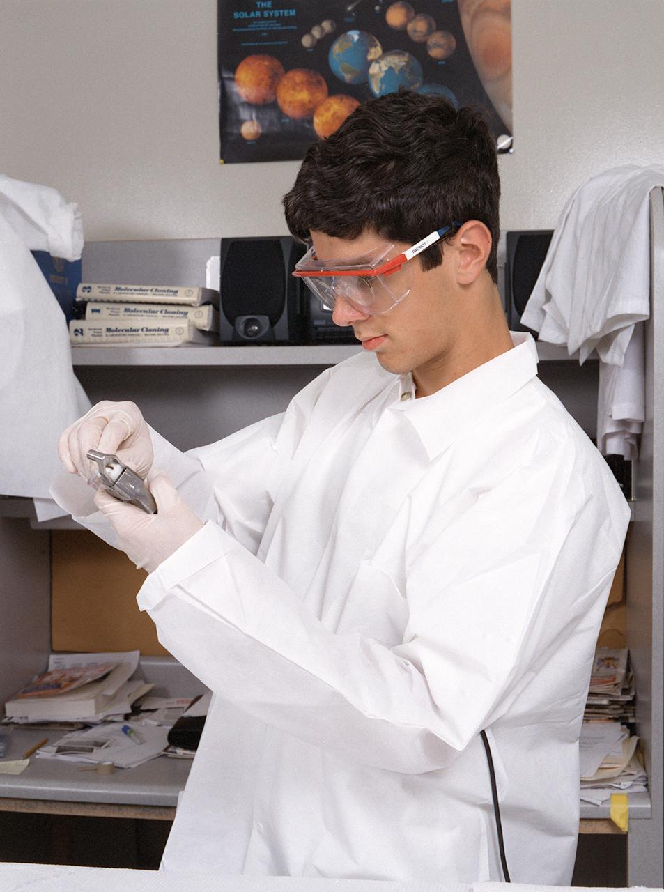 A Memphis student working at the University of Alabama in Huntsville prepares samples for the first protein crystal growth experiments plarned to be performed aboard the International Space Station (ISS). The proteins are placed in plastic tubing that is heat-sealed at the ends, then flash-frozen and preserved in a liquid nitrogen Dewar. Aboard the ISS, the nitrogen will be allowed to evaporated so the samples thaw and then slowly crystallize. They will be analyzed after return to Earth. Photo credit: NASA/Marshall Space Flight Center (MSFC)