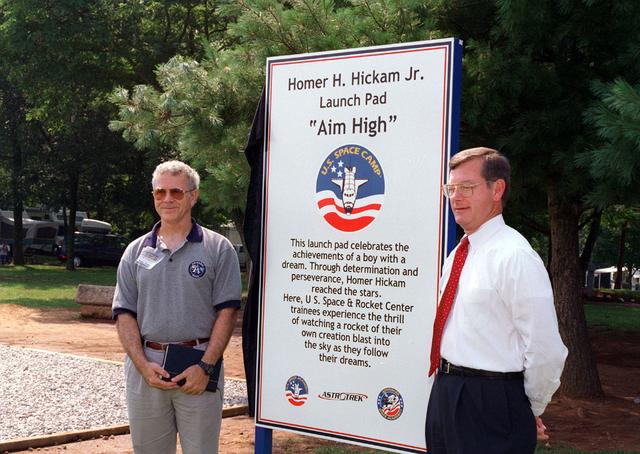 Noted author and previous Marshall Space Flight Center employee Mr. Homer Hickam Jr. poses in front of a placque commemorating his achievement in realizing his dreams of becoming a rocket scientist. The dedication site is located at the U. S. Space and Rocket Center in Huntsville, AL, and is used by amature rocket builders attending the Space Camp to launch their self-made rockets like Mr. Hickam did as a youth growing up in rural West Virginia. Posing with Mr. Hickam is the Madison County Commissioner Mr. Mike Gillispie.